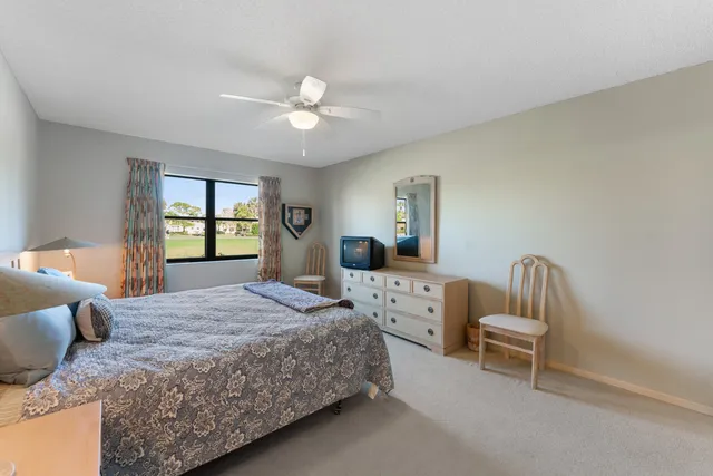 a bedroom with a bed chair and window