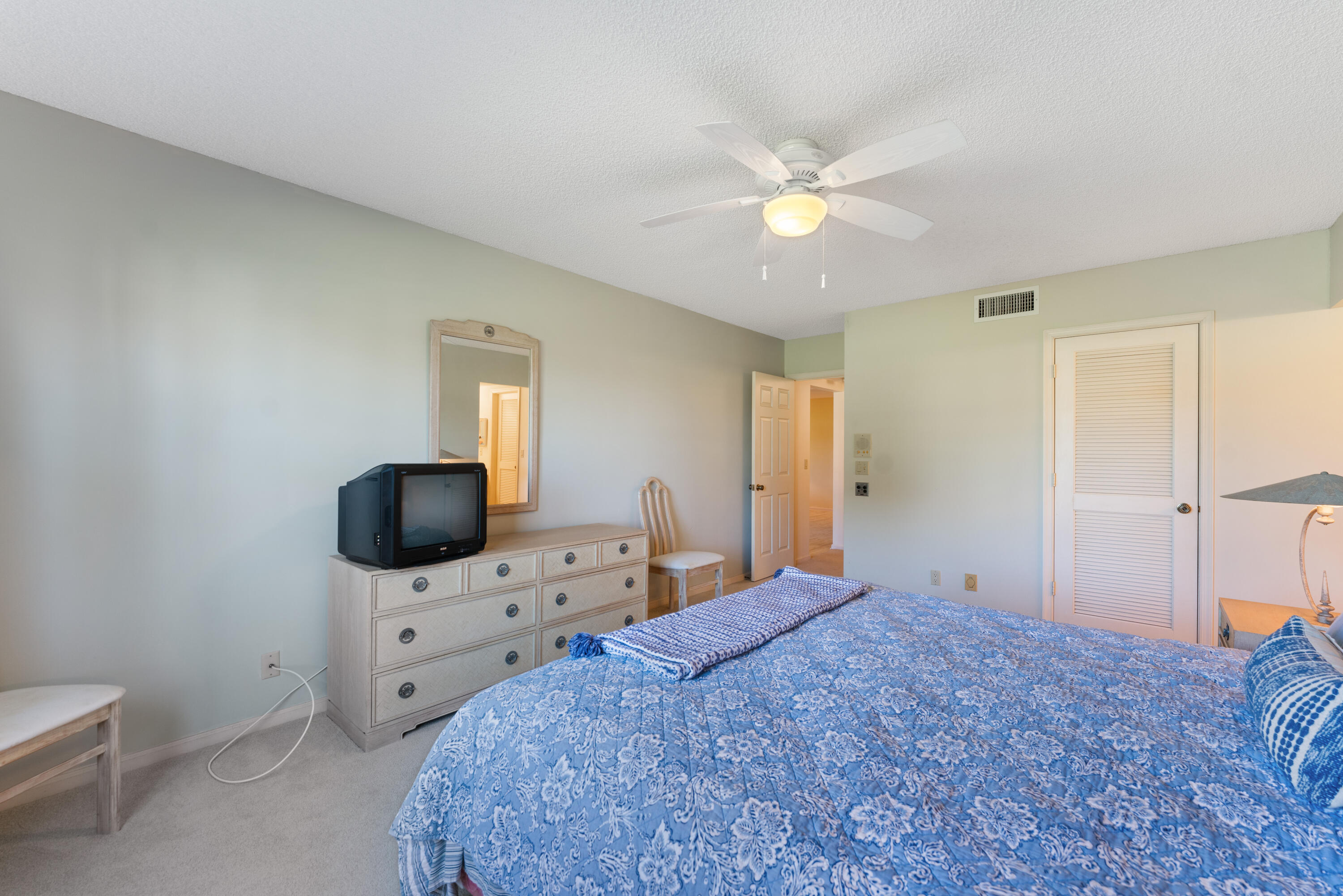 16970 Waterbend Drive, Unit 146 Jupiter, FL 33477 - Photo 19 of 30 a bedroom with a bed and a flat screen tv