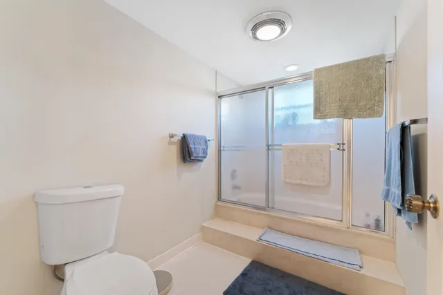 a bathroom with a toilet and a shower