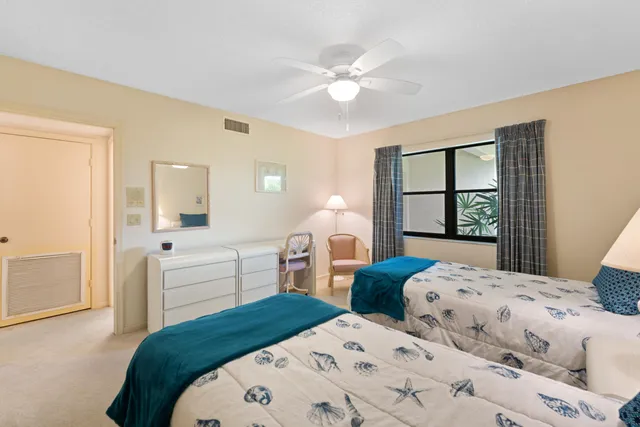 a bedroom with two beds and a window