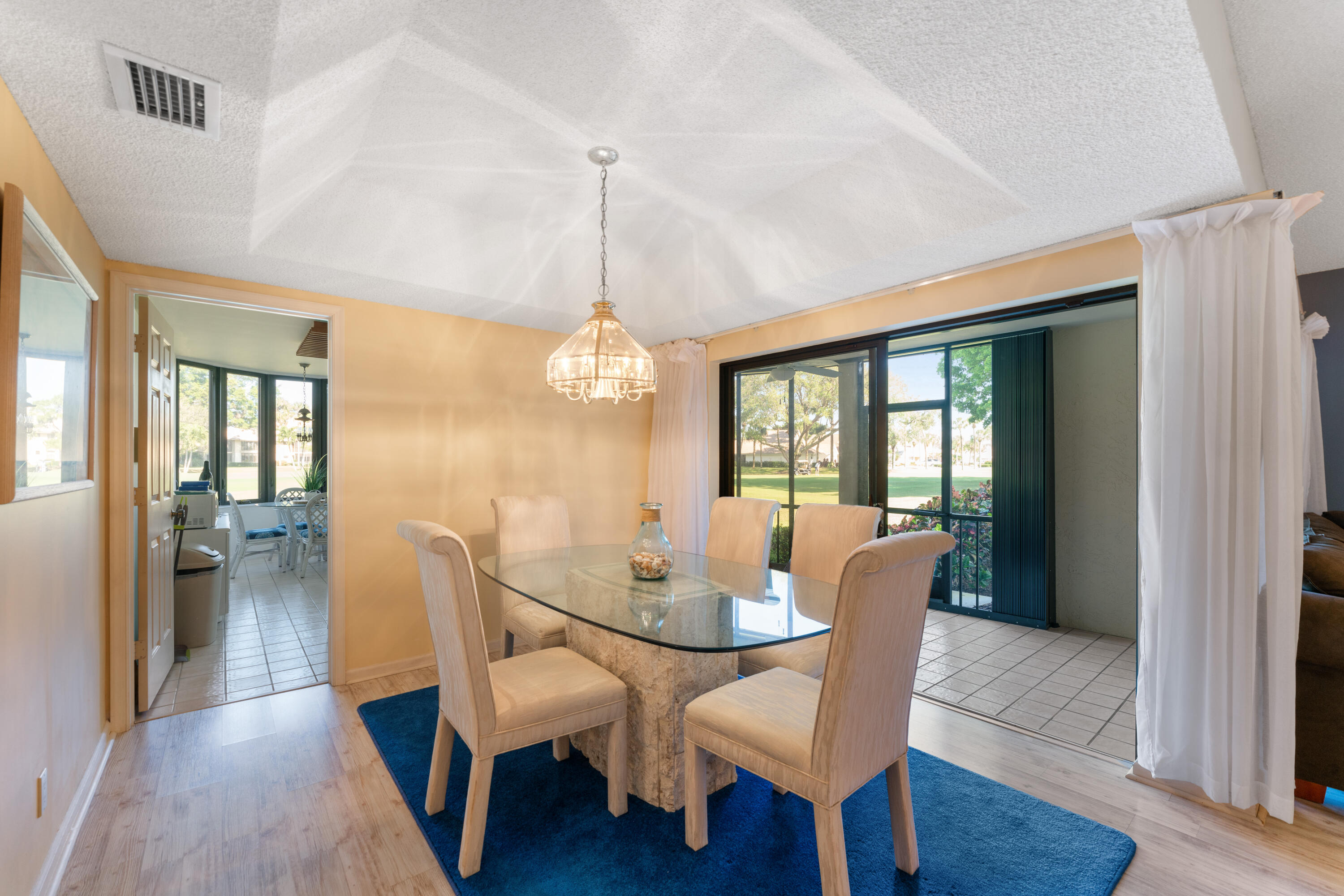 16970 Waterbend Drive, Unit 146 Jupiter, FL 33477 - Photo 8 of 30 a view of a dining room with furniture window and wooden floor