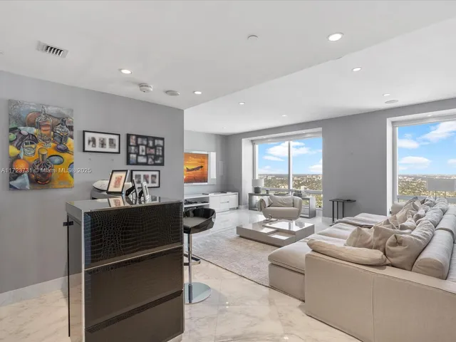 a living room with furniture flat screen tv and a window