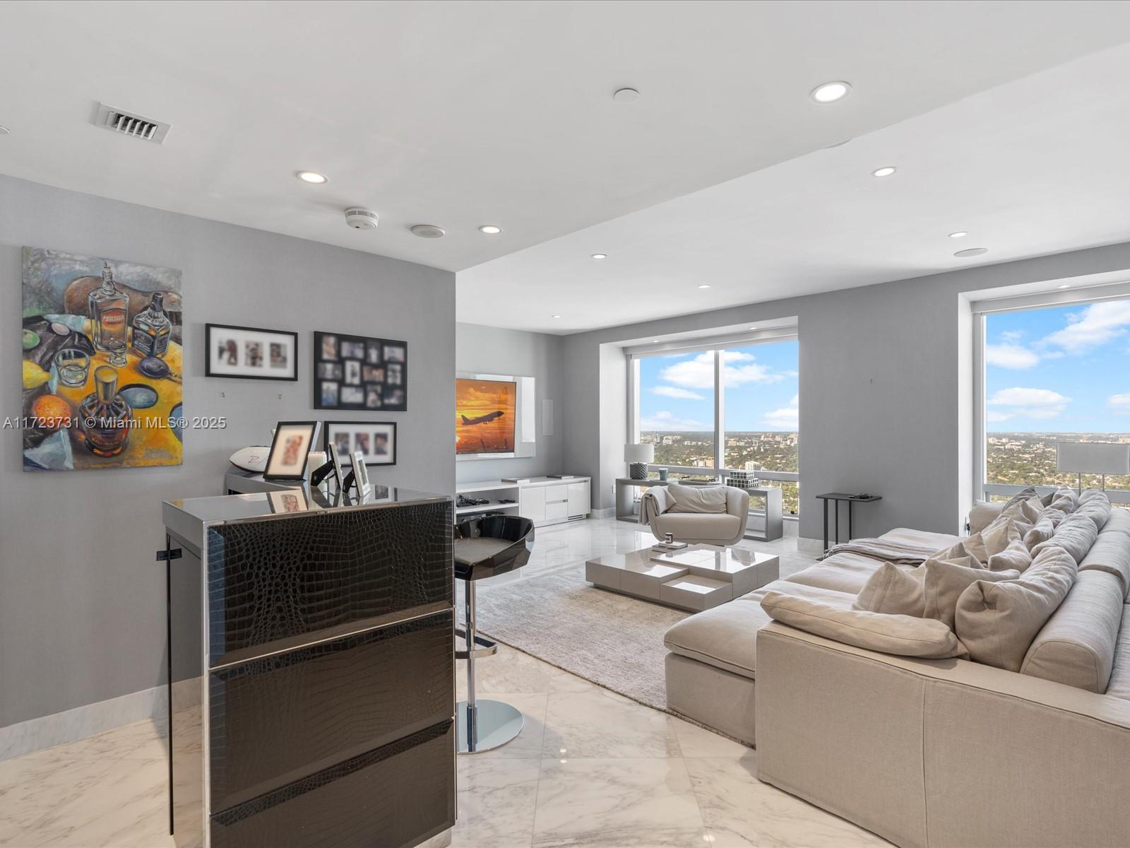 1425 Brickell Avenue, Unit 52BC Miami, FL 33131 - Photo 13 of 72 a living room with furniture flat screen tv and a window