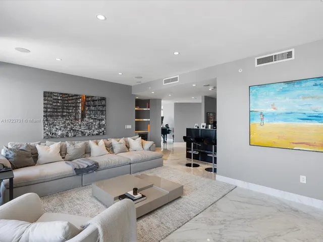 a living room with furniture wooden floor and a flat screen tv