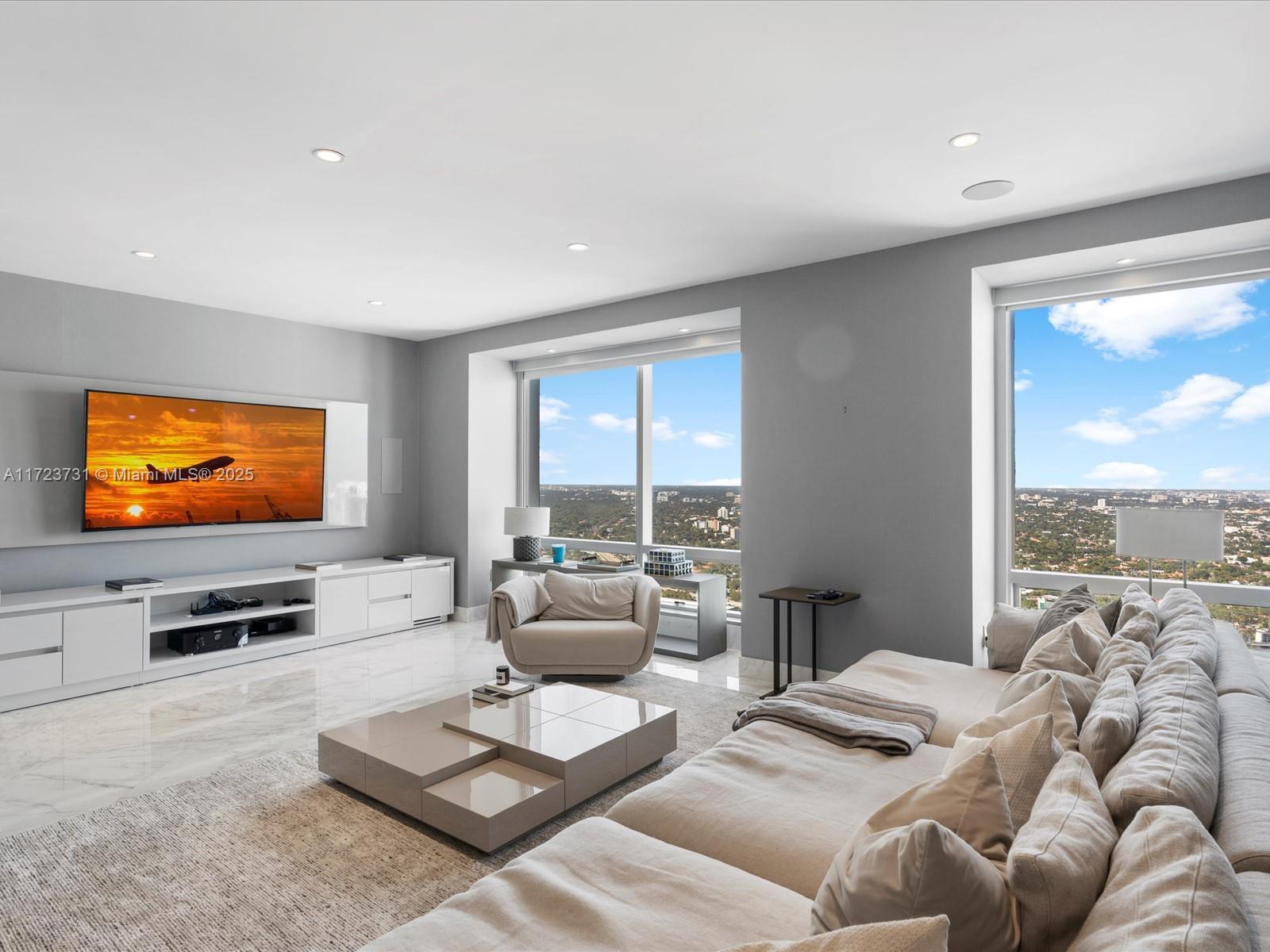 1425 Brickell Avenue, Unit 52BC Miami, FL 33131 - Photo 17 of 72 a living room with furniture wooden floor and a flat screen tv