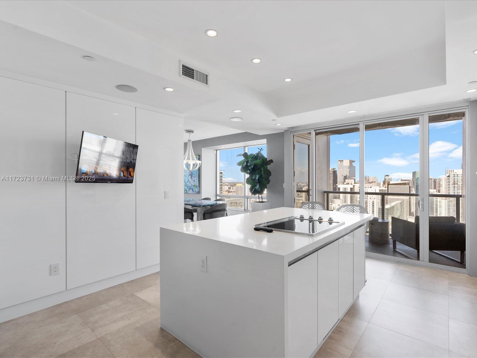1425 Brickell Avenue, Unit 52BC Miami, FL 33131 - Photo 18 of 72 a living room with stainless steel appliances kitchen island granite countertop a sink and a refrigerator