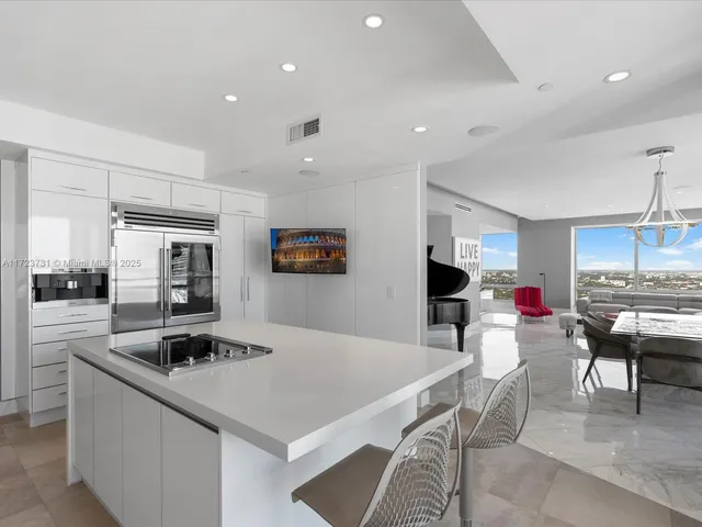 a kitchen with center island a sink stainless steel appliances and cabinets