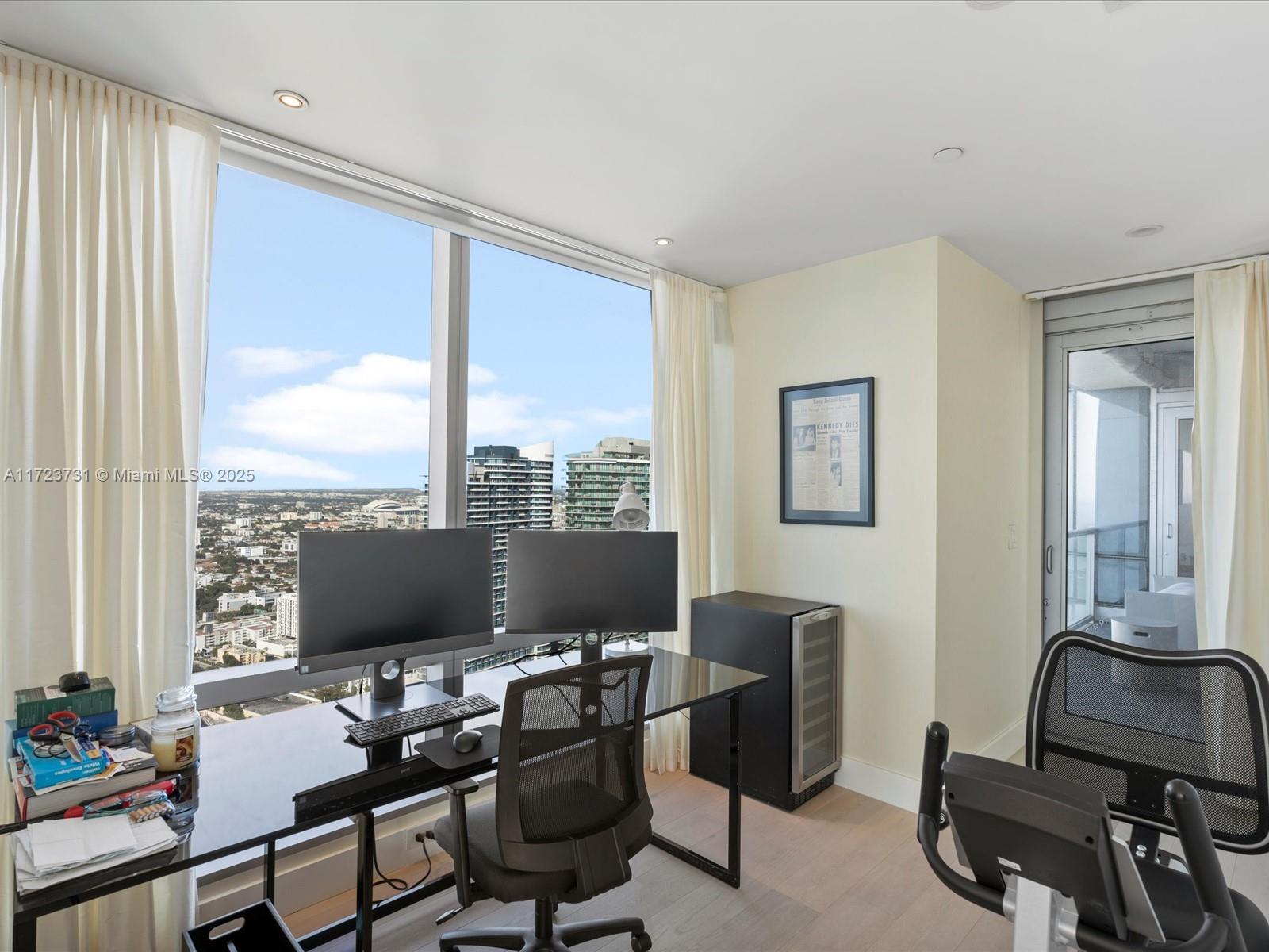 1425 Brickell Avenue, Unit 52BC Miami, FL 33131 - Photo 30 of 72 a view of a workspace with furniture and a window