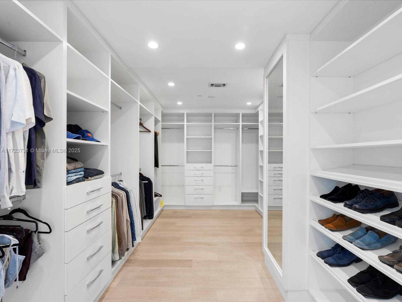 1425 Brickell Avenue, Unit 52BC Miami, FL 33131 - Photo 37 of 72 a view of walk in closet with clothes and shoes