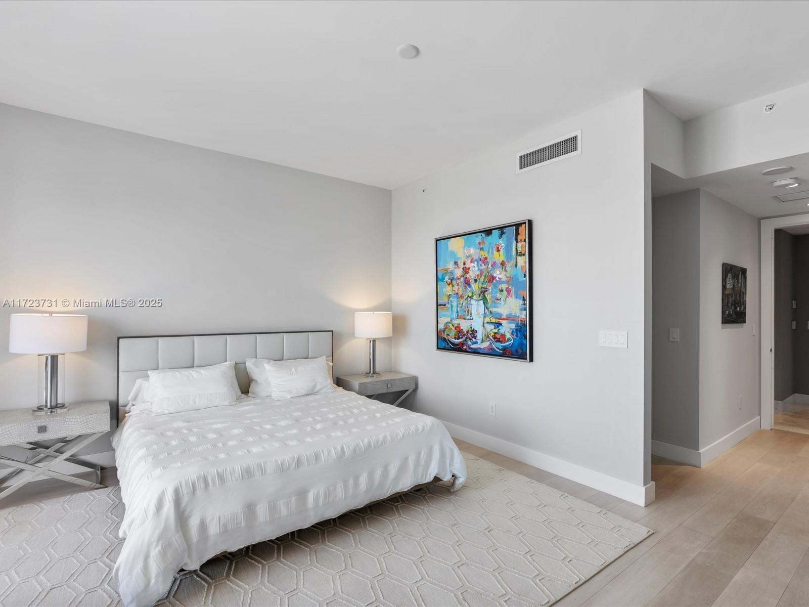 1425 Brickell Avenue, Unit 52BC Miami, FL 33131 - Photo 39 of 72 a bedroom with a bed and a night stand