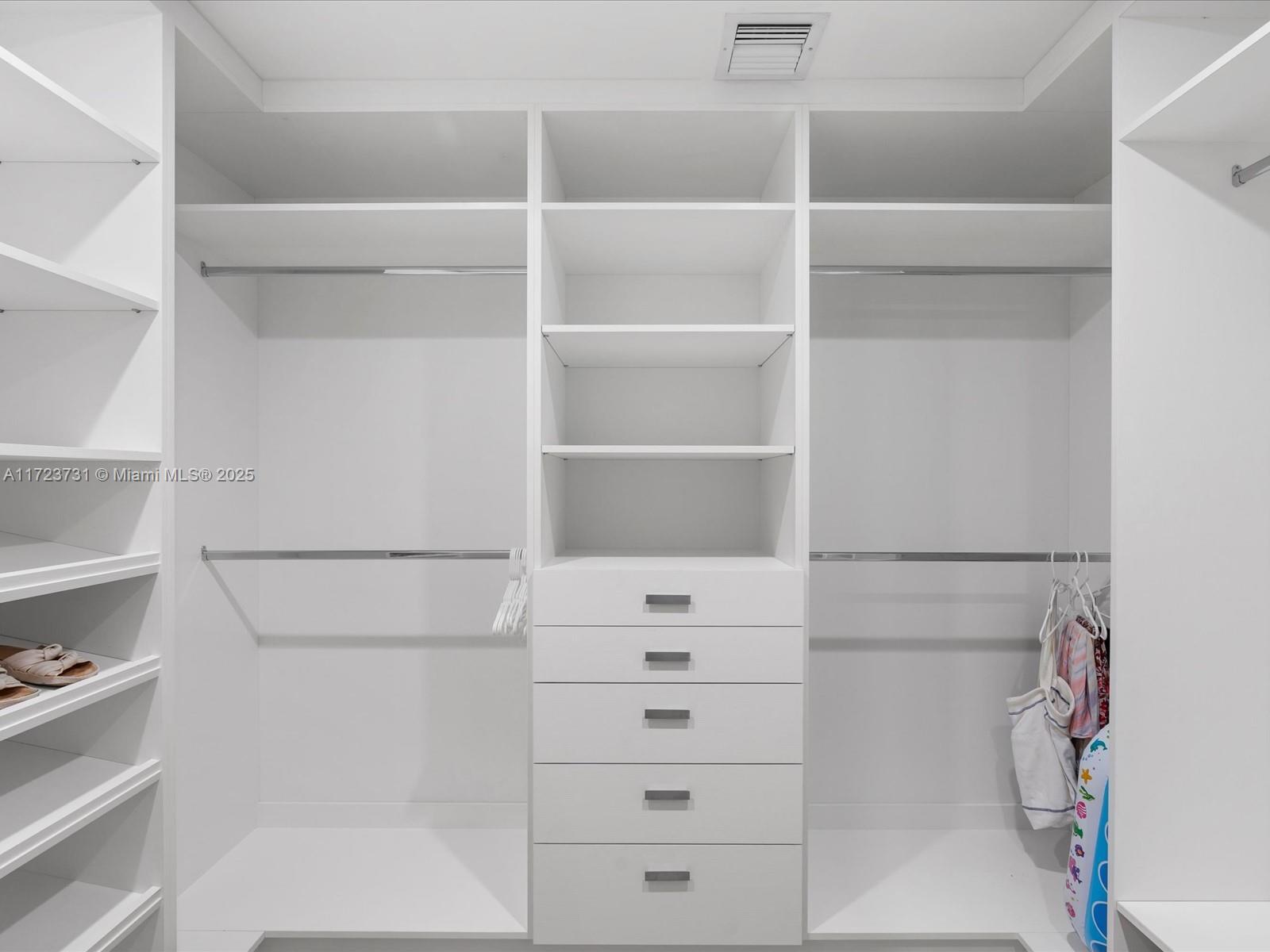 1425 Brickell Avenue, Unit 52BC Miami, FL 33131 - Photo 45 of 72 a view of walk in closet with empty racks