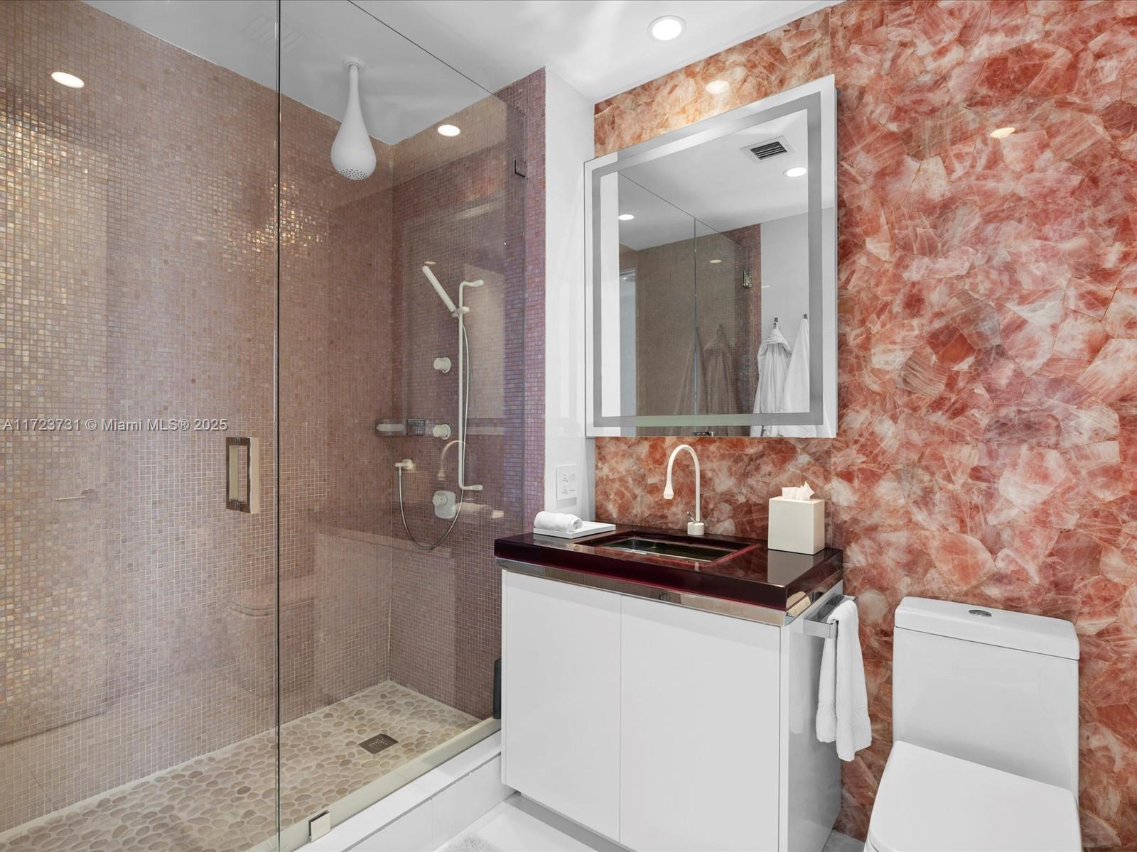 1425 Brickell Avenue, Unit 52BC Miami, FL 33131 - Photo 48 of 72 a bathroom with a sink a toilet and shower