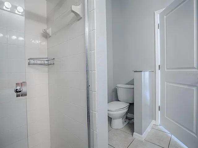 a bathroom with a toilet and a shower