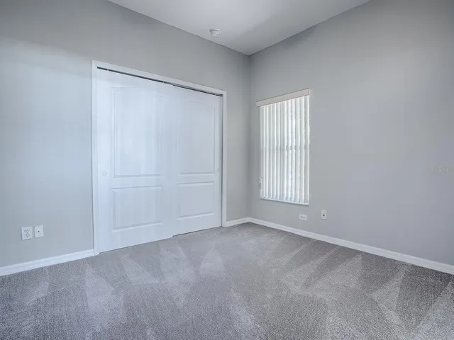 a view of an empty room with closet area
