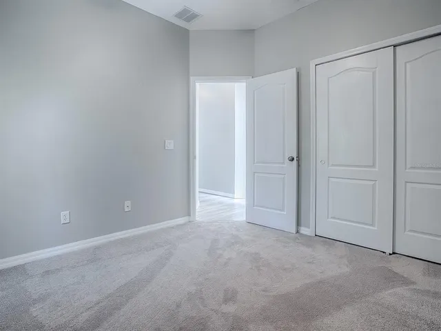 a view of an empty room and closet area