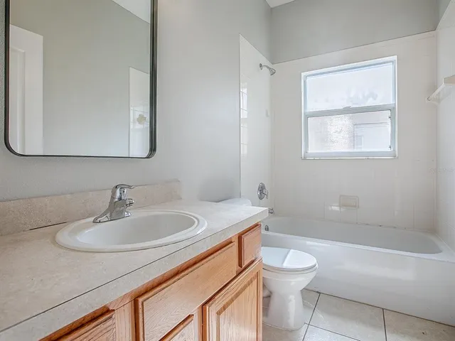 a bathroom with a sink a toilet and bathtub
