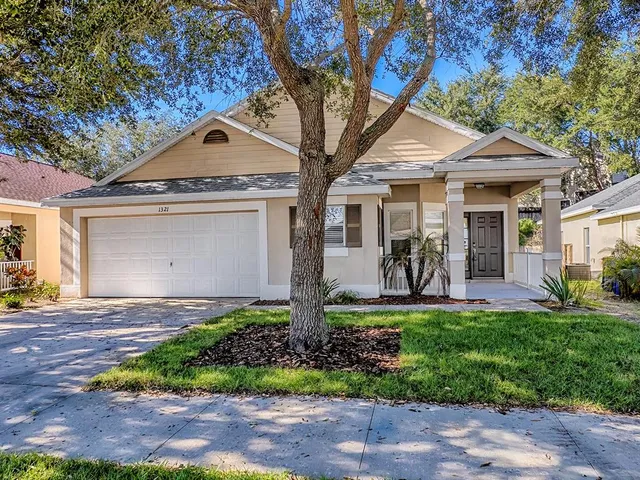 a front view of a house with garden and porch