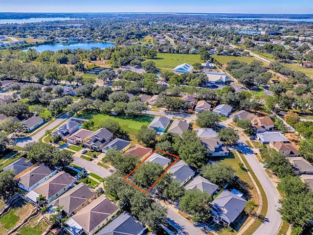 an aerial view of residential houses with outdoor space