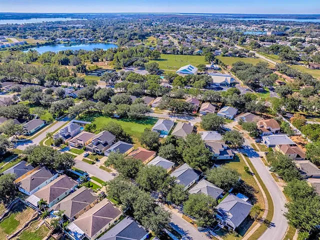 an aerial view of residential houses with outdoor space