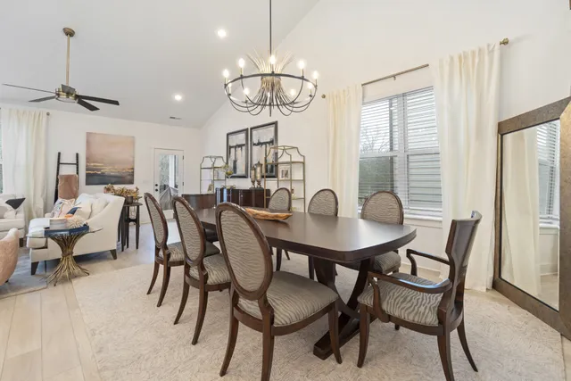 a view of a dining room with furniture and a chandelier