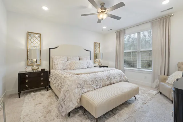 a bedroom with a large bed and a window