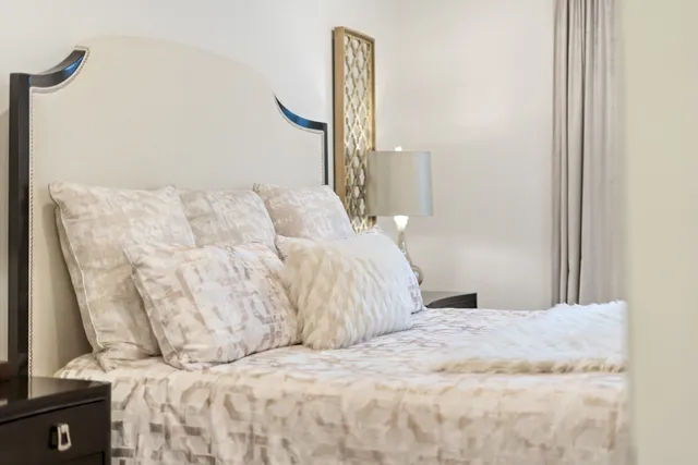 a bedroom with a bed and a lamp