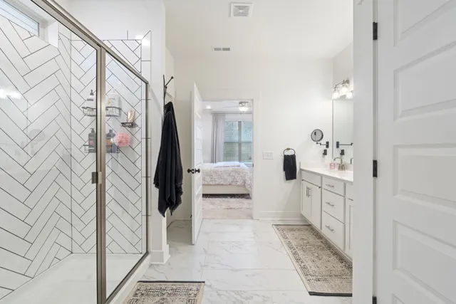 a bathroom with a double vanity sink and mirror
