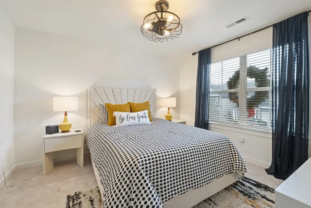 a bedroom with a bed and a window