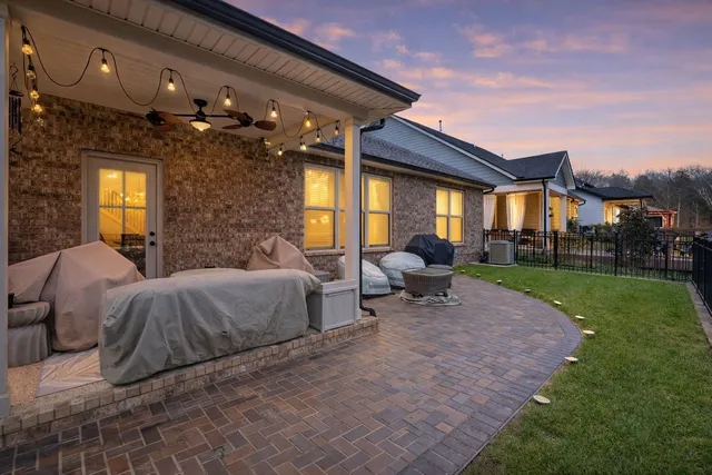 a view of a porch with furniture and garden