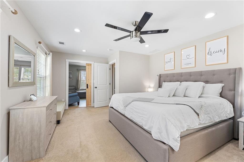 221 Laurel Avenue Southwest Atlanta, GA 30314 - Photo 16 of 29 a spacious bedroom with a large bed and a chandelier