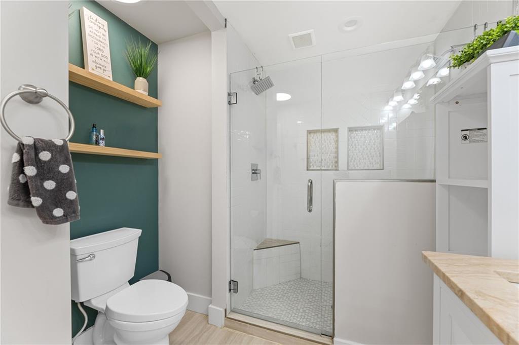 221 Laurel Avenue Southwest Atlanta, GA 30314 - Photo 18 of 29 a bathroom with a granite countertop sink mirror vanity and toilet