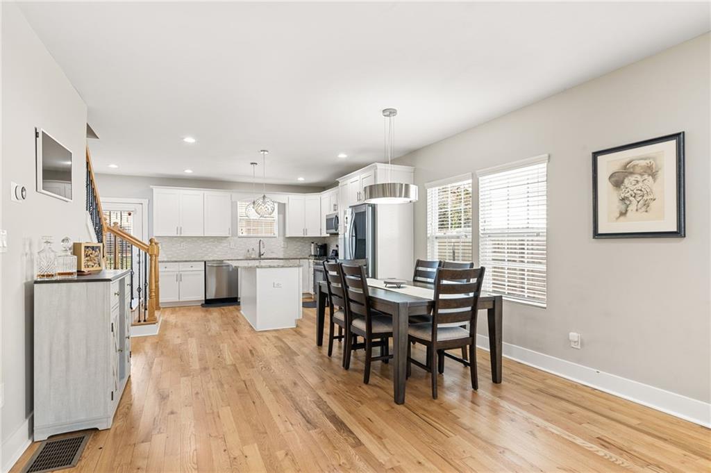 221 Laurel Avenue Southwest Atlanta, GA 30314 - Photo 29 of 29 a kitchen with stainless steel appliances kitchen island granite countertop a table chairs sink and cabinets