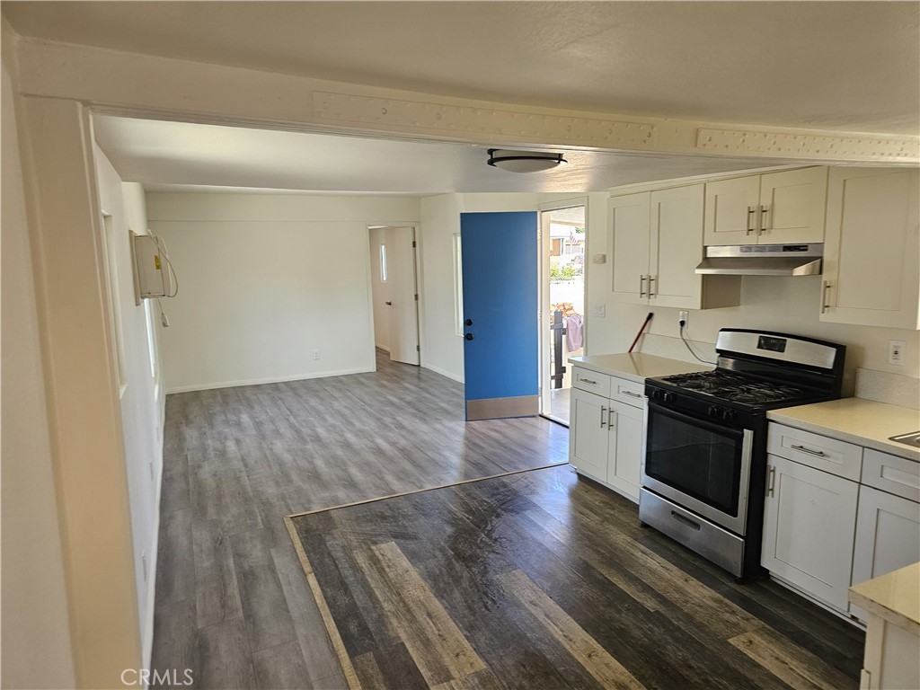 22775 Raymond Road Perris, CA 92570 - Photo 11 of 23 a kitchen with granite countertop wooden floors and stainless steel appliances