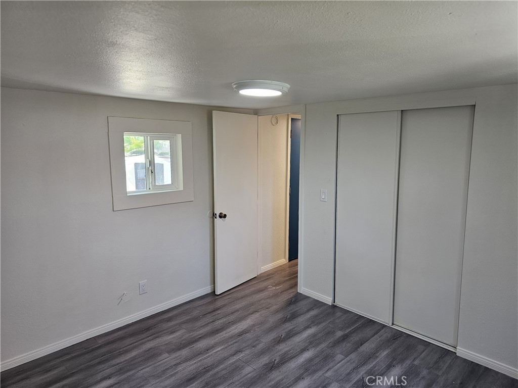 22775 Raymond Road Perris, CA 92570 - Photo 13 of 23 a view of an empty room with wooden floor and a window