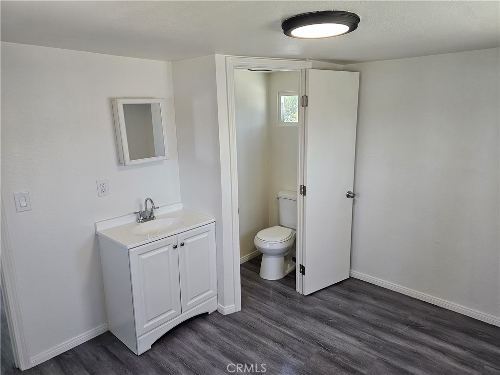 22775 Raymond Road Perris, CA 92570 - Photo 19 of 23 a bathroom with a sink a toilet and a mirror