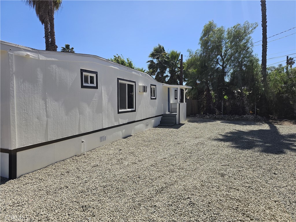 22775 Raymond Road Perris, CA 92570 - Photo 3 of 23 a backyard of a house with garage and yard