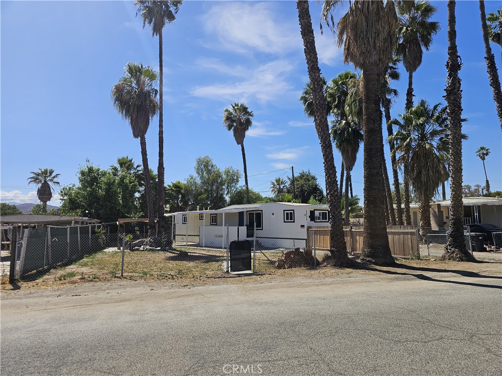 22775 Raymond Road Perris, CA 92570 - Photo 4 of 23 a row of palm trees sitting in front of a house