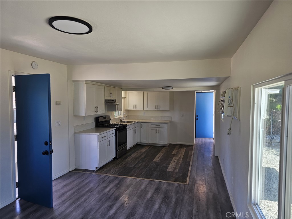 22775 Raymond Road Perris, CA 92570 - Photo 10 of 23 a kitchen with cabinets and wooden floor