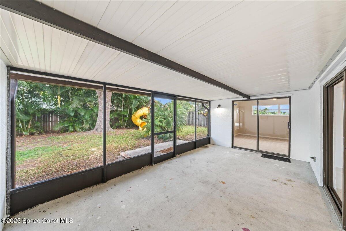 2010 Talloak Road Melbourne, FL 32935 - Photo 17 of 45 a view of an empty room with sliding glass door