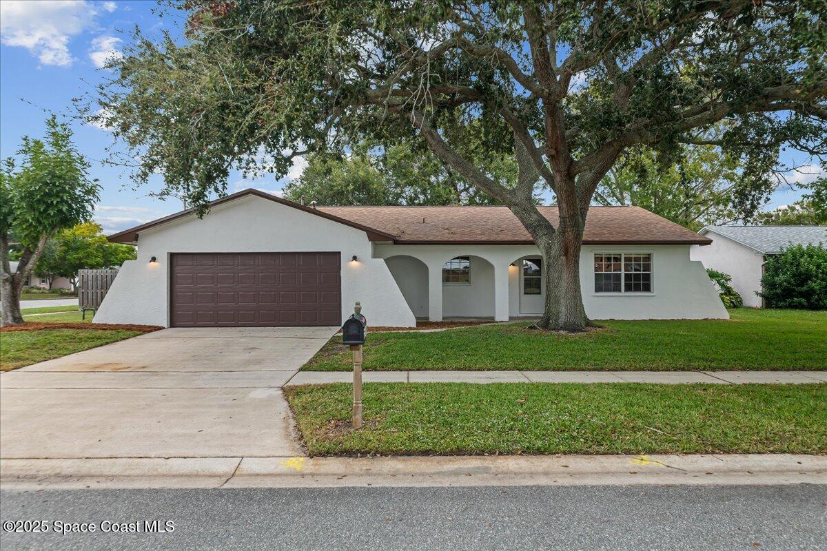 2010 Talloak Road Melbourne, FL 32935 - Photo 28 of 45 a front view of a house with a garden