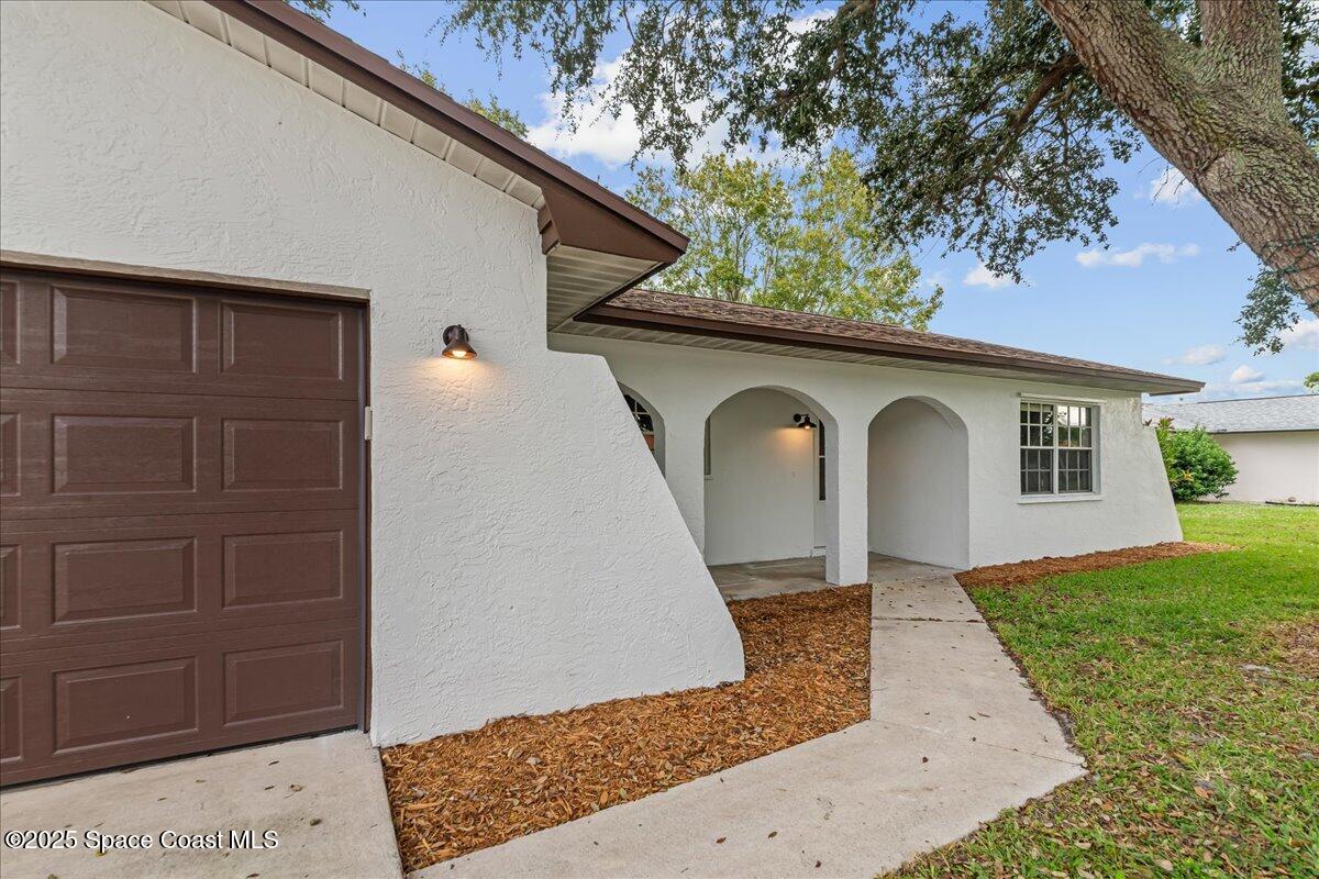 2010 Talloak Road Melbourne, FL 32935 - Photo 29 of 45 a front view of a house with garden