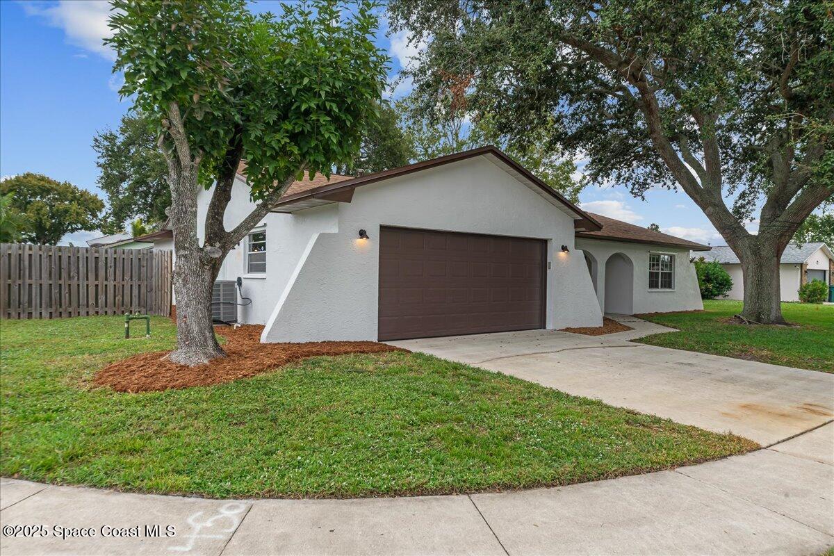 2010 Talloak Road Melbourne, FL 32935 - Photo 32 of 45 a front view of a house with a yard and tree