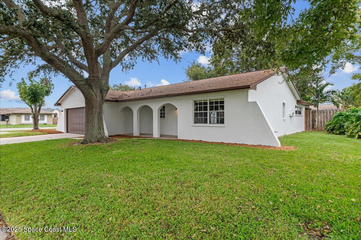 2010 Talloak Road Melbourne, FL 32935 - Photo 33 of 45 a view of a house with a yard
