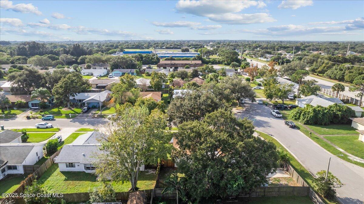 2010 Talloak Road Melbourne, FL 32935 - Photo 35 of 45 an aerial view of a house with a swimming pool yard and lake view in back