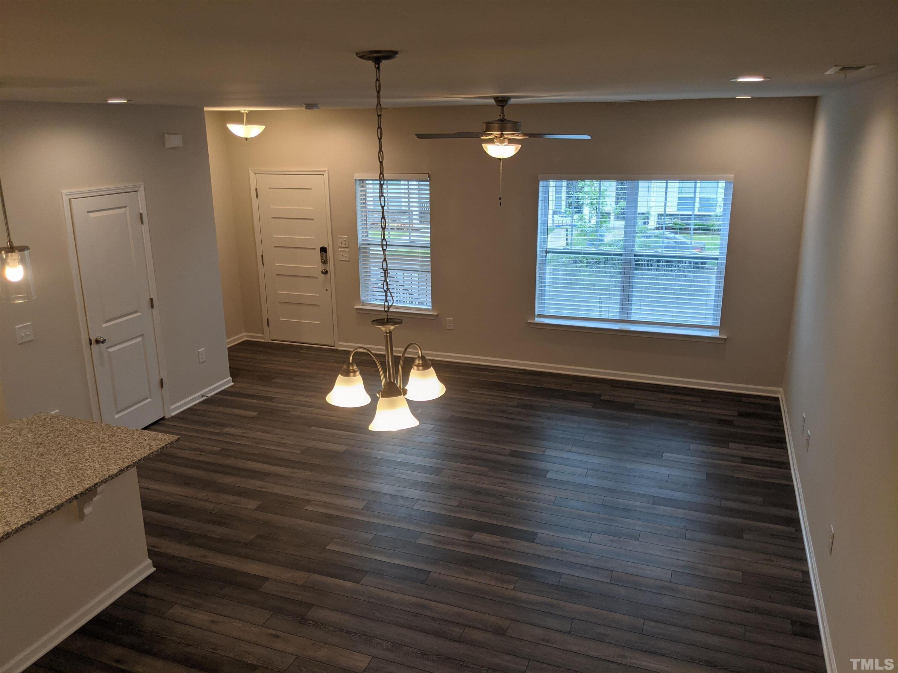 912 Robbie Jackson Lane Fuquay-Varina, NC 27526 - Photo 2 of 10 an empty room with wooden floor and windows
