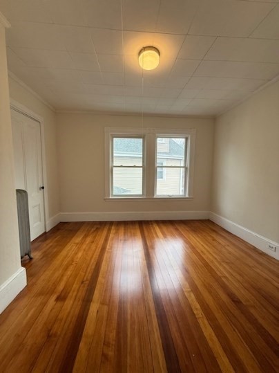 5 Alcott Street, Unit 2 Boston, MA 02134 - Photo 10 of 14 an empty room with wooden floor and windows