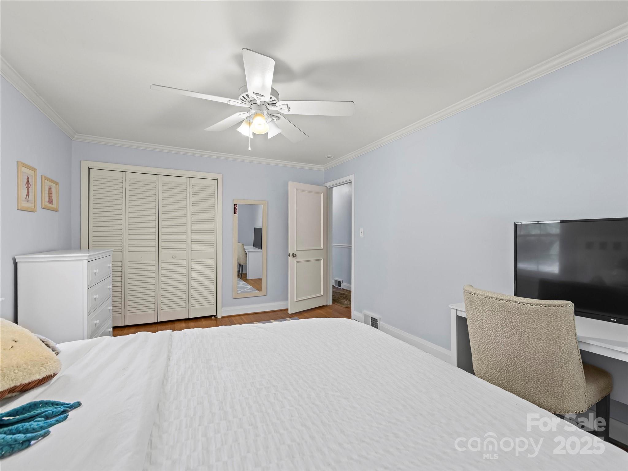 9 Hilltop Road Asheville, NC 28803 - Photo 14 of 34 a bedroom with a bed and a chandelier