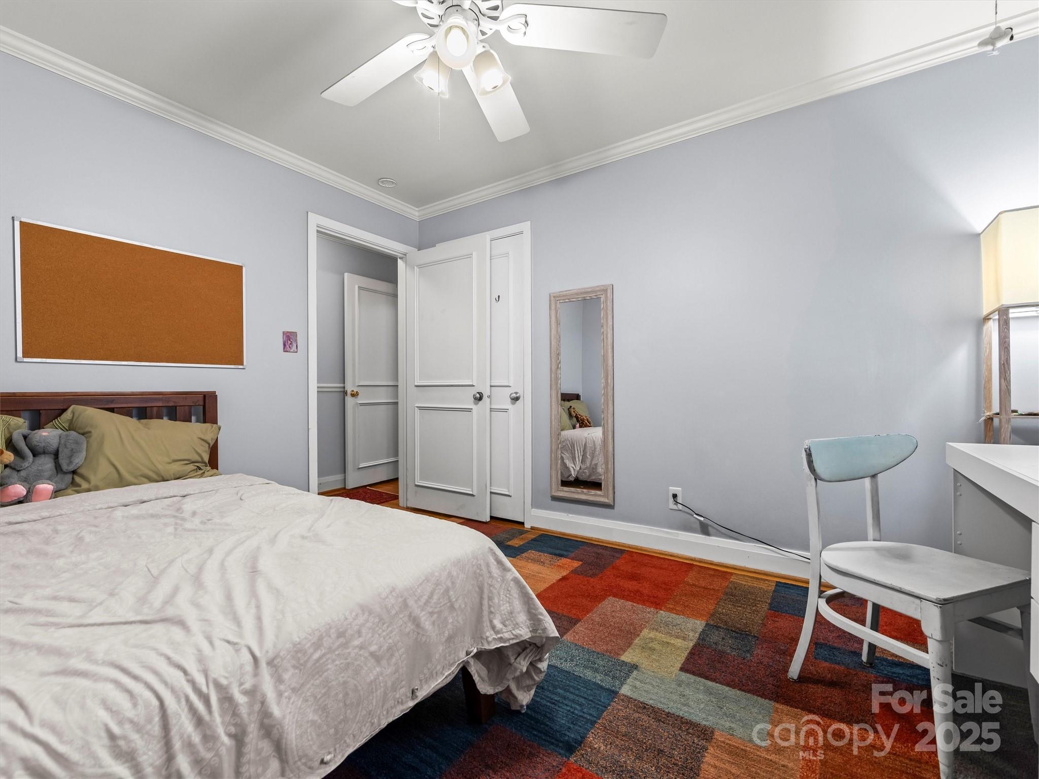 9 Hilltop Road Asheville, NC 28803 - Photo 17 of 34 a bedroom with a bed and a chandelier