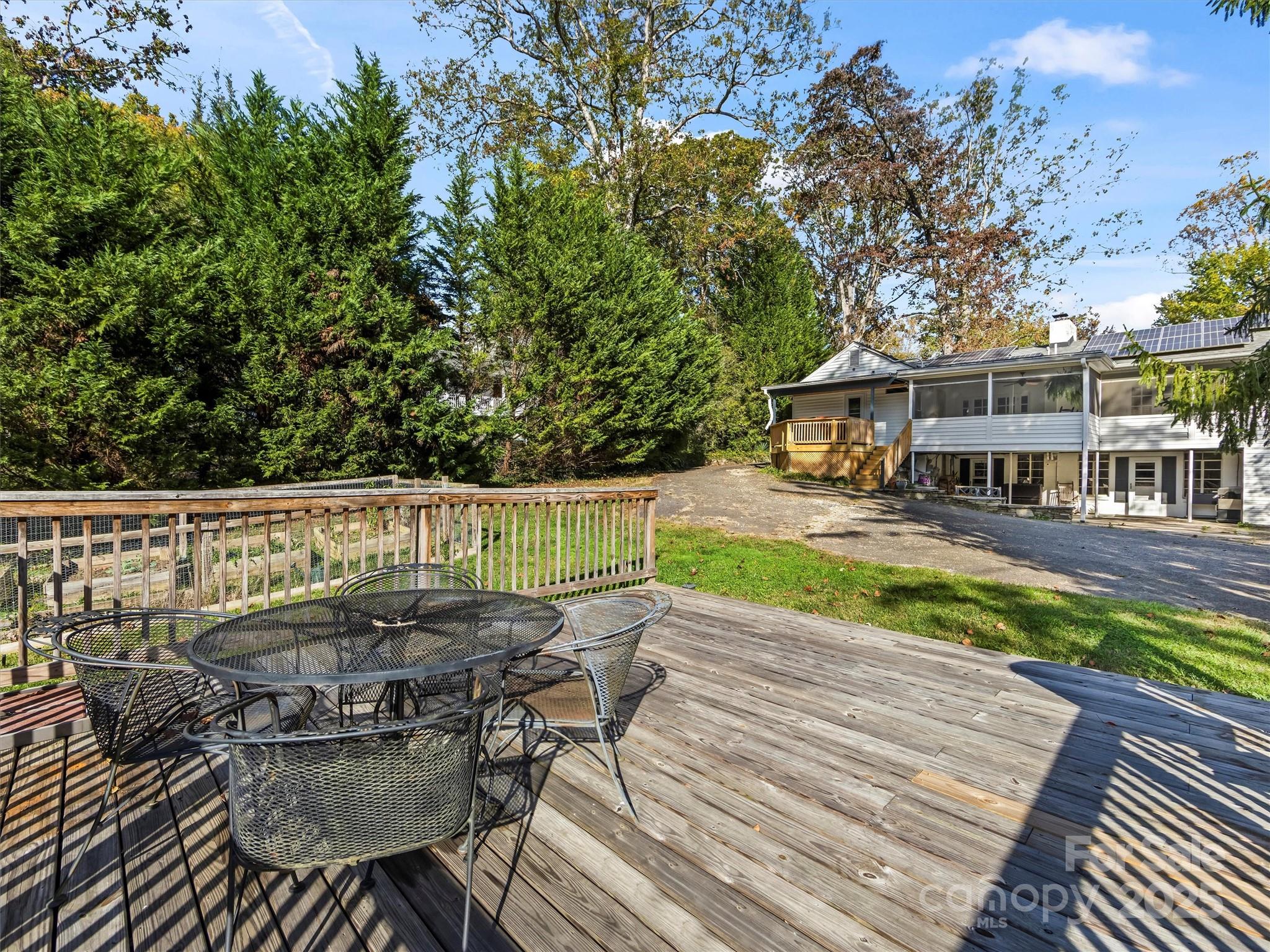 9 Hilltop Road Asheville, NC 28803 - Photo 32 of 34 a view of a chairs and table on the wooden deck