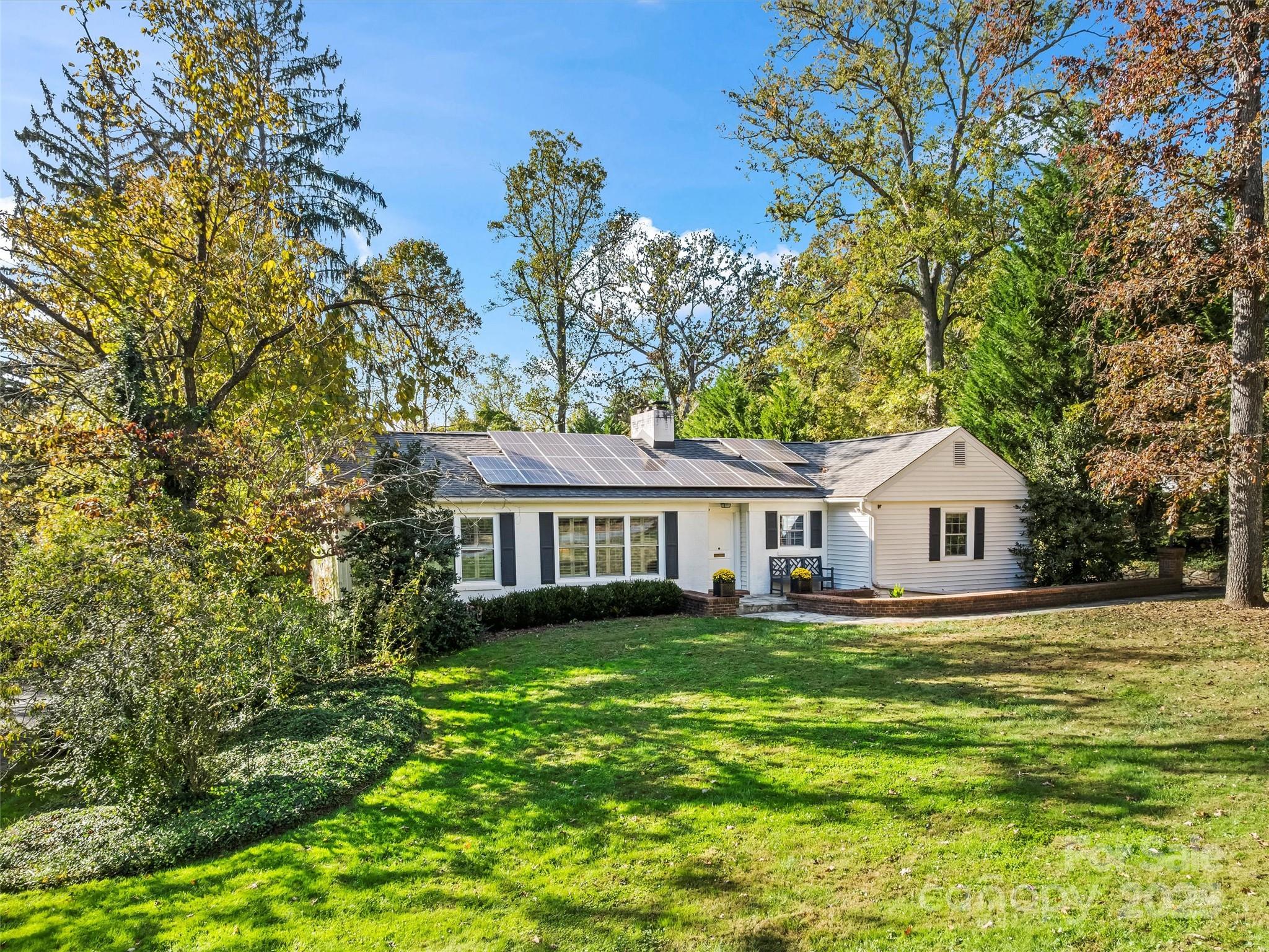9 Hilltop Road Asheville, NC 28803 - Photo 4 of 34 a front view of a house with a garden